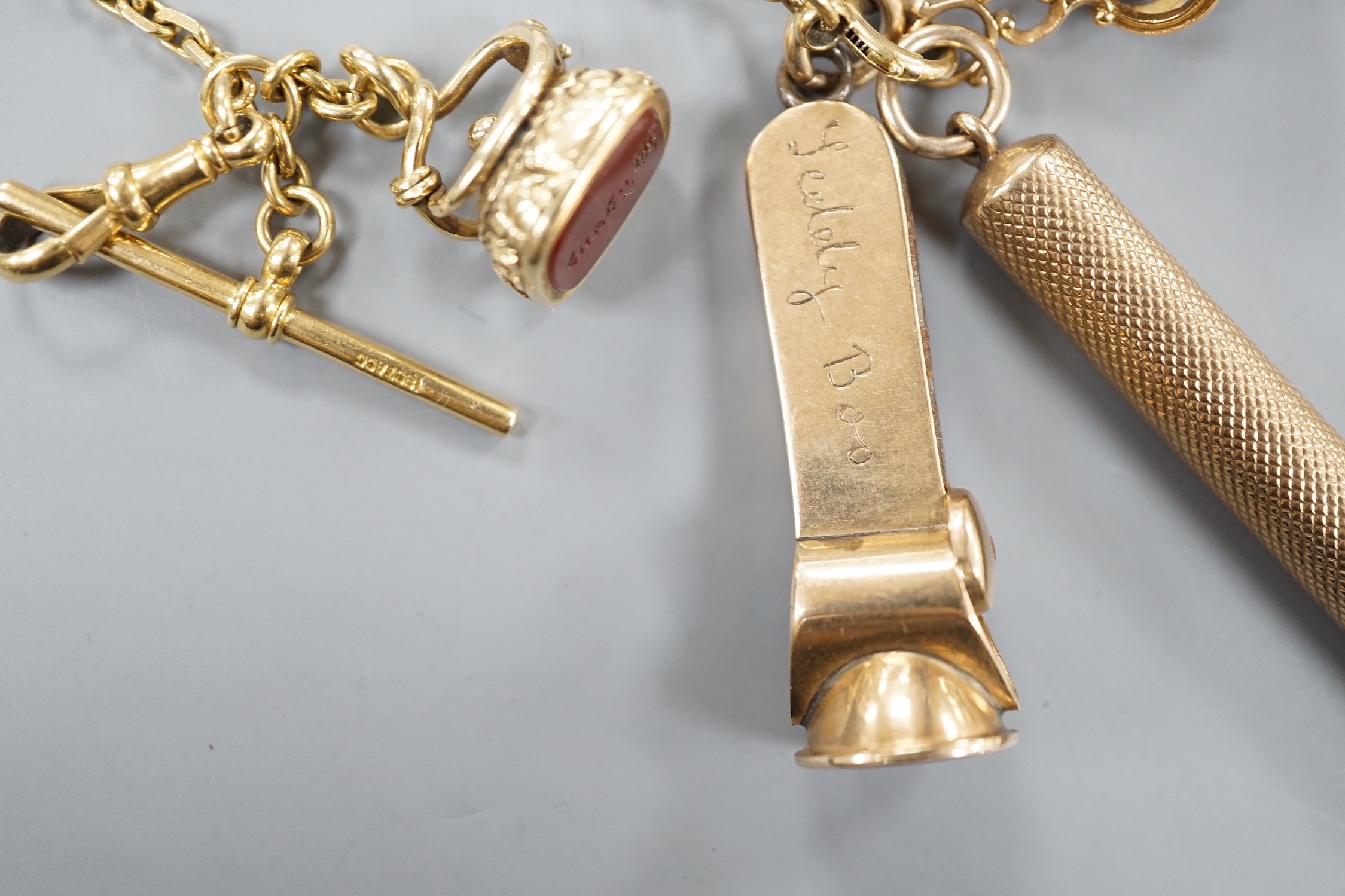 An 18ct albert chain, 33cm, 15 grams, hung with two 19th century yellow metal overlaid and carnelian fob seals, a yellow metal overlaid propelling pencil and a 9ct gold mounted cigar cutter.
